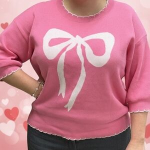 Pink Sweater with White Bow Design